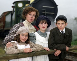 Kids and their mother in front of a train